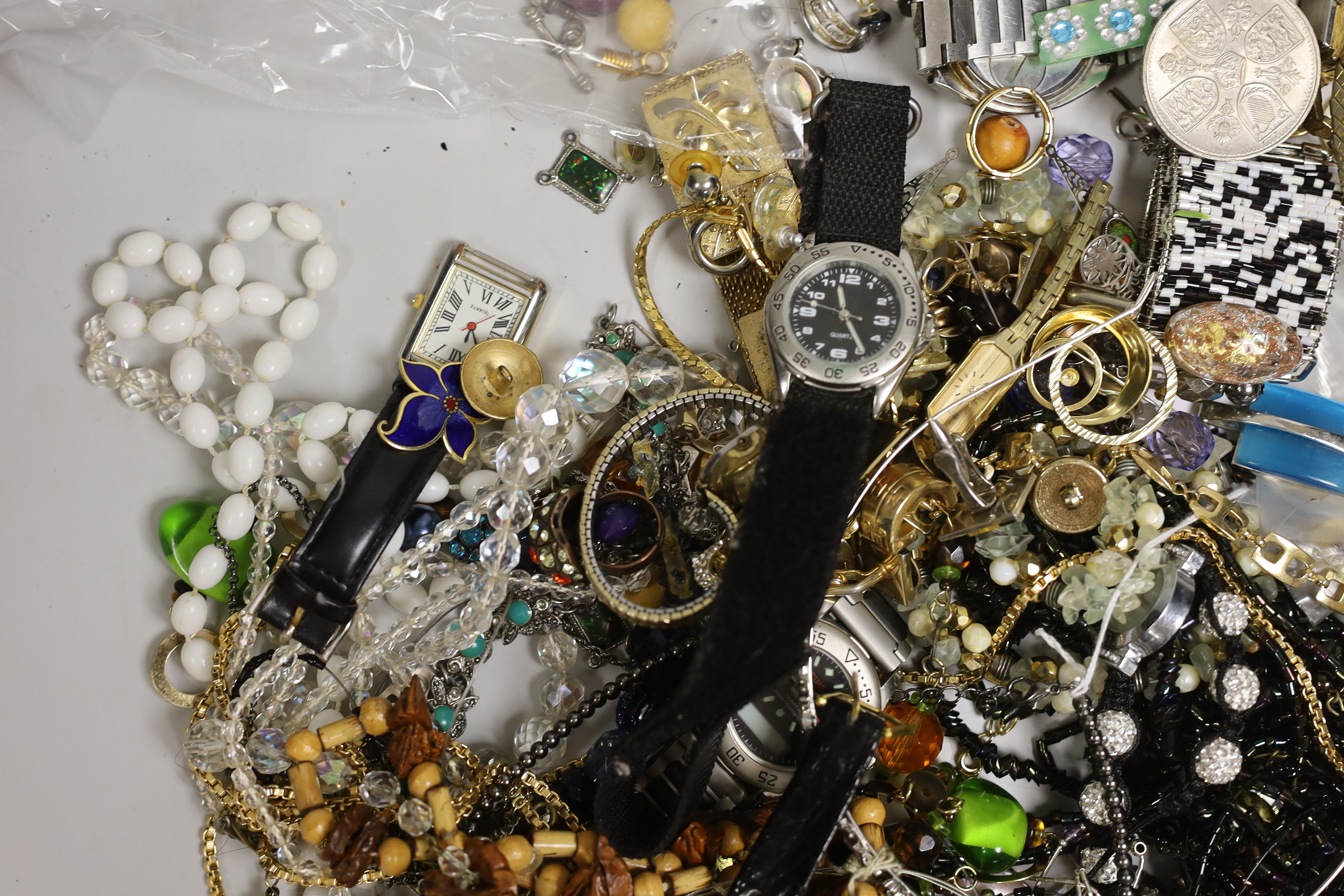 A box of costume jewellery including silver brooches and pendants.